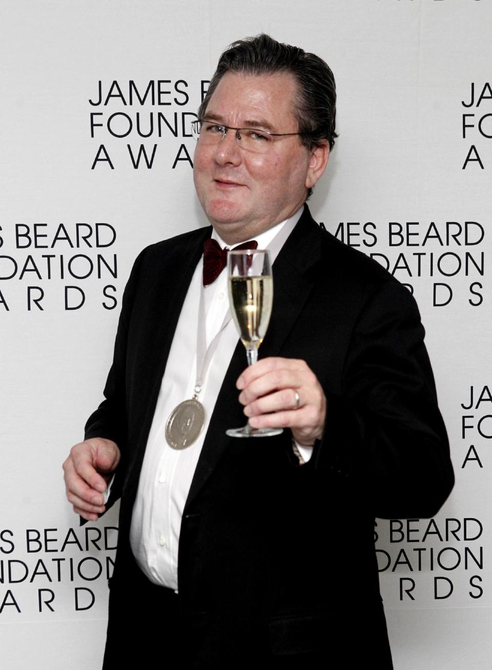 Chef Charlie Trotter poses with his medal for Humanitarian of the Year, during the James Beard Foundation Awards, Monday, May 7, 2012, in New York. (AP Photo/Jason DeCrow)