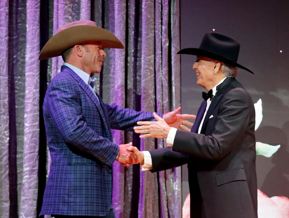 Rudy Ramos, right, presents Taylor Sheridan accepts the award for Outstanding Fictional Drama Presentation for "1883" Season 1, Episode 1 during the Western Heritage Awards at the National Cowboy & Western Heritage Museum in Oklahoma City, Saturday, April, 9, 2022.  