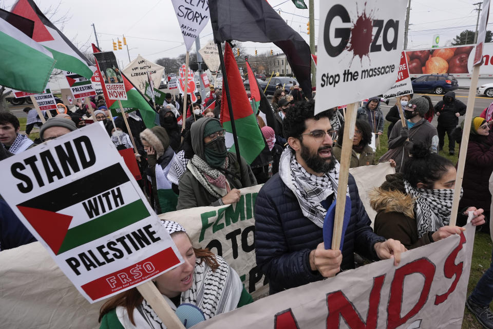 FILE - Pro-Palestinian demonstrators march during a visit by President Joe Biden in Warren, Mich., Feb. 1, 2024. Biden is dispatching several senior aides to Michigan to meet with Arab American and Muslim leaders as the administration’s handling of the Israel-Hamas war continues to frustrate members of a key constituency in a 2024 battleground state. That's according to three people familiar with the matter. (AP Photo/Paul Sancya, File)