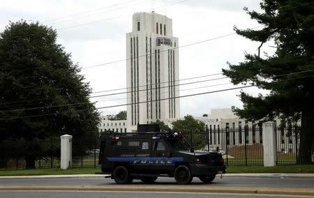 A police armored personnel carrier patrols outside the campus of the Walter Reed National Military Medical Center (formerly known as Bethesda Naval Hospital) as police investigate a report of a gunshot heard at the U.S. Navy facilty in the Washington suburb of Bethesda, Maryland, July 6, 2015. REUTERS/Kevin Lamarque