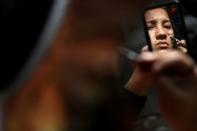 Samela Satere-Mawe, a 24-year-old biology student and Indigenous activist prepares traditional painting at her home in Manaus