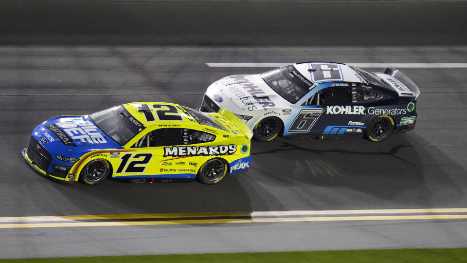 Brad Keselowski (6) begins to get around Ryan Blaney (12) during the first of two NASCAR Daytona 500 qualifying auto races Thursday, Feb. 17, 2022, at Daytona International Speedway in Daytona Beach, Fla. Keselowski won the race. (AP Photo/Chris O'Meara)