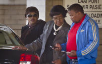 <p>Former wife Winnie Madikizela-Mandela, center, and daughter Zindzi Mandela, left, leave the Mediclinic Heart Hospital where former South African President Nelson Mandela was being treated in Pretoria, South Africa, on June 14, 2013. (Photo: Ben Curtis/AP) </p>