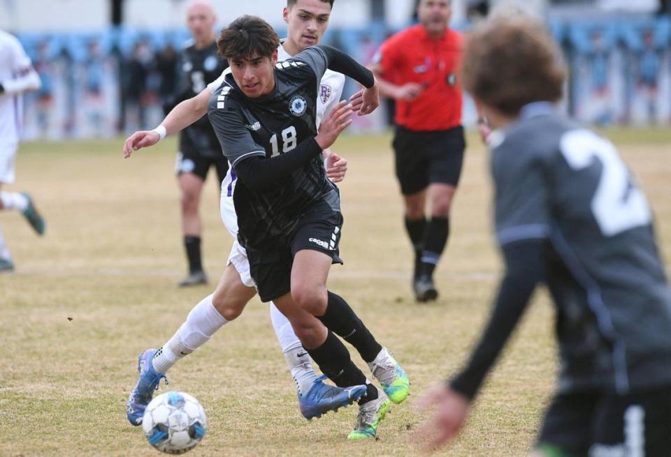 Clovis North’s Bryan Lopez, center, chased by Ridgeview’s Joshua Bryant, background, seen in the Central Section Boys Division I soccer championship Saturday, Feb. 25, 2023 in Clovis. Lopez scored the first and third goals in the team’s 3-1 win over Ridgeview.