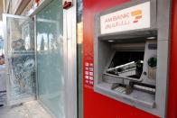 A damaged ATM machine of AM Bank is pictured in Beirut