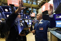 Trader Craig Spector, left, and specialist John Parisi work on the floor of the New York Stock Exchange, Thursday, July 18, 2019. U.S. stocks moved lower in early trading on Wall Street Thursday after Netflix reported a slump in new subscribers and dragged down communications companies. (AP Photo/Richard Drew)