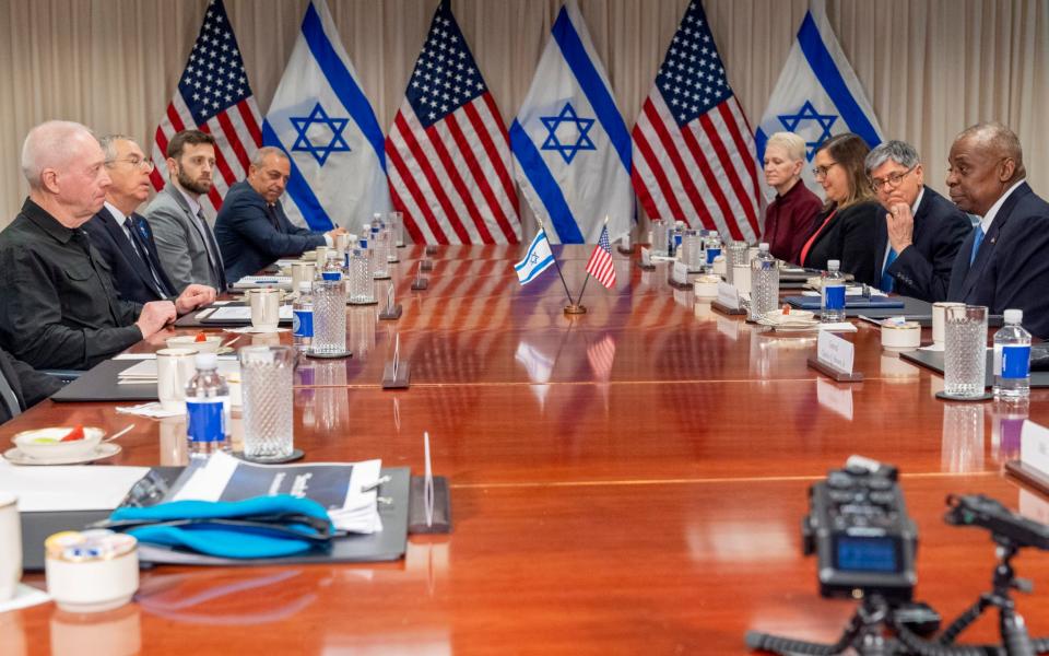 Lloyd Austin (far right) and Yoav Gallant (left across table) meet at the Pentagon on Tuesday