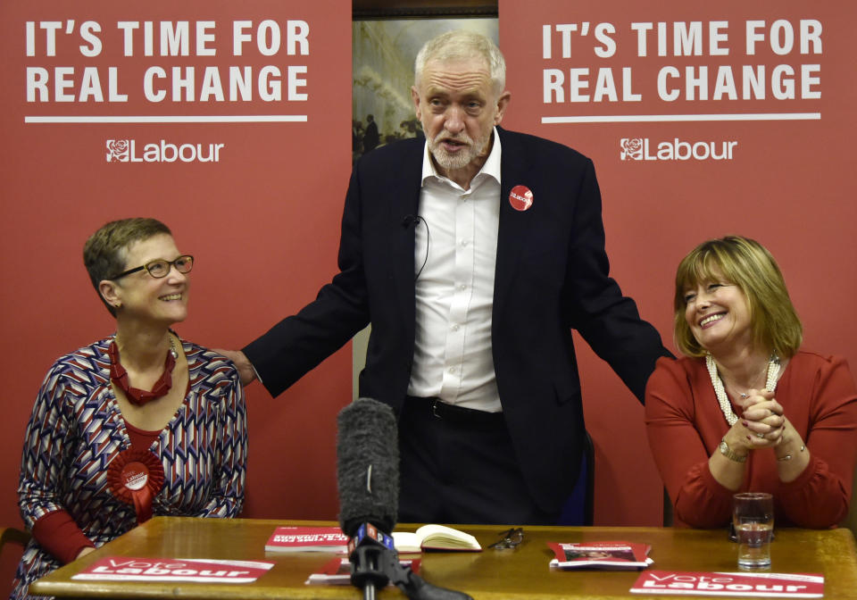 Britain's main opposition Labour Party leader Jeremy Corbyn, centre, with Dudley North candidate Melanie Dudley, right, and Dudley South candidate Lucy Caldicott at the Pensioner Club in Dudley, England, Thursday, Nov. 21, 2019, as the UK prepares for a General Election on Dec. 12. (AP Photo/Rui Vieira)