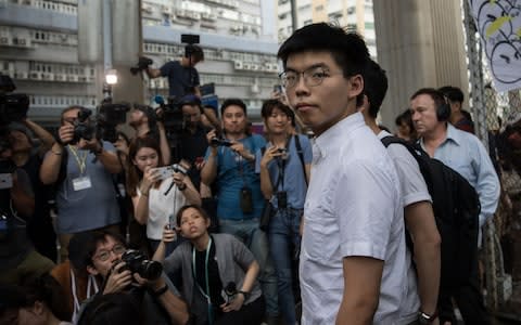 Joshua Wong thanks the media after being released  - Credit: Rex
