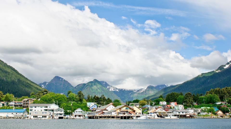 View of Sitka, Alaska from the water with the mountains behind the town during summer