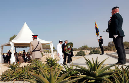 British Ambassador to Egypt, Sir Geoffrey Adams carries a wreath of flowers as he takes part in a ceremony for the anniversary of the Battle of El Alamein, at El Alamein war cemetery in Egypt, October 20, 2018. REUTERS/Amr Abdallah Dalsh