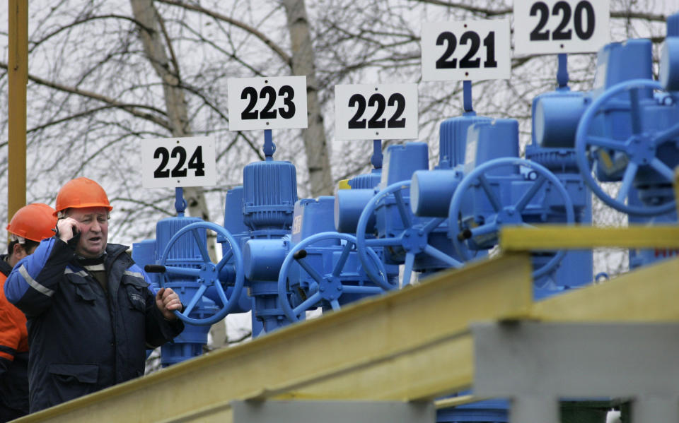 FILE - Workers at a pump station on the "Druzhba" pipeline near the village Bobovichi, some 330 km (206 miles) southeast of Minsk, Belarus, on Jan. 11, 2007. Europe is short of gas. Russia could in theory supply more beyond its long-term agreements, but hasn't, leading to accusations it is holding back to pressure Europe to approve a new controversial Russian pipeline. (AP Photo/Sergei Grits, File)