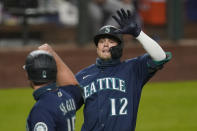 Seattle Mariners' Evan White (12) is congratulated by Kyle Seager after hitting a three-run home run against the Houston Astros in the seventh inning of a baseball game Monday, Sept. 21, 2020, in Seattle. (AP Photo/Elaine Thompson)