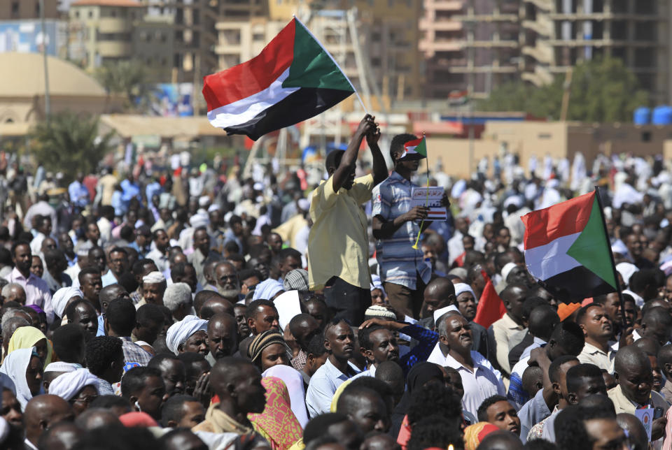 Supporters of Sudan’s President Omar al-Bashir wave national flags at a pro-government rally in Khartoum, Sudan, Wednesday, Jan. 9, 2019. Al-Bashir told the gathering of several thousands of supporters in the capital that he is ready to step down only “through election.” The remarks come after three weeks of anti-government protests. (AP Photo/Mahmoud Hjaj)