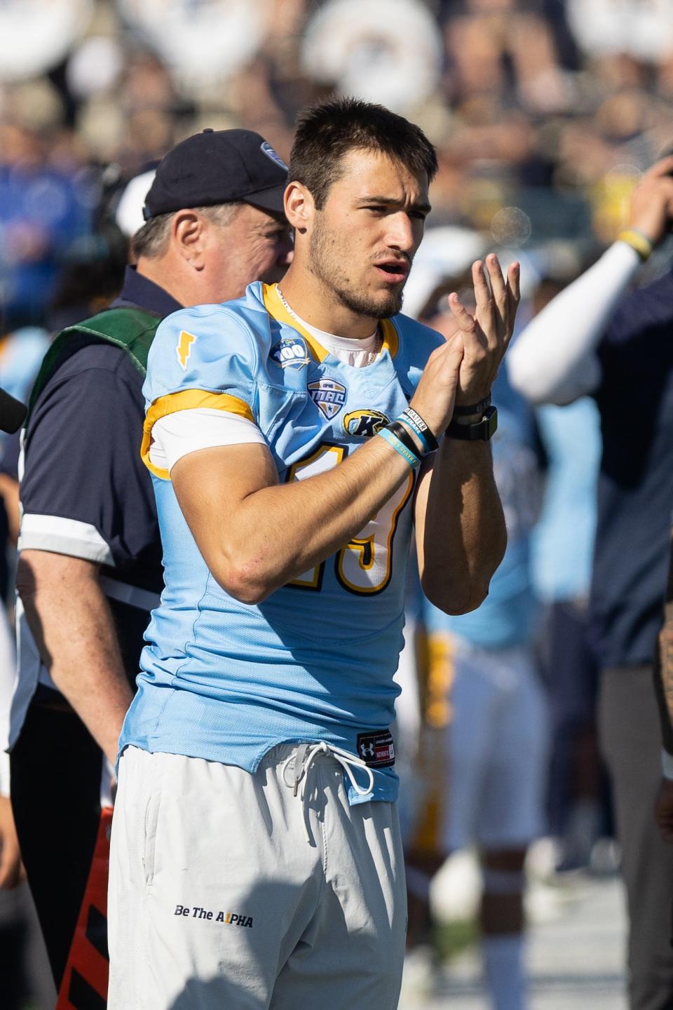 Injured Kent State quarterback Collin Schlee cheers on his team from the sideline during Saturday’s game against the Akron Zips at Kent State University’s Dix Stadium.