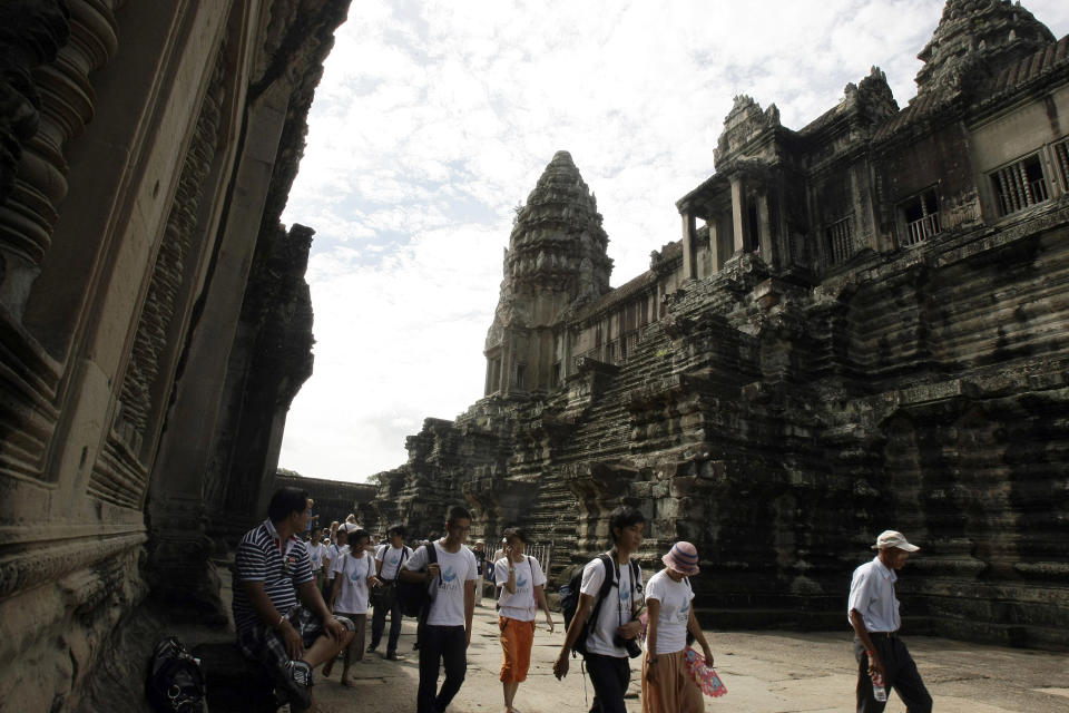 In this Thursday, July 19, 2012 file photo, tourists take a tour to the Angkor Wat temple complex in Siem Reap, some 230 kilometers (143 miles) northwest of Phnom Penh, Cambodia. The spectacular temples of Cambodia’s historic Angkor civilization have been incorporated into Google’s Street View. The Internet giant said in a statement Thursday, April 3, 2014 that Street View now includes more than 90,000 photographic panoramas of the area, and allows viewers to zoom in to study carvings and other artistic and archaeological details. (AP Photo/Heng Sinith, File)