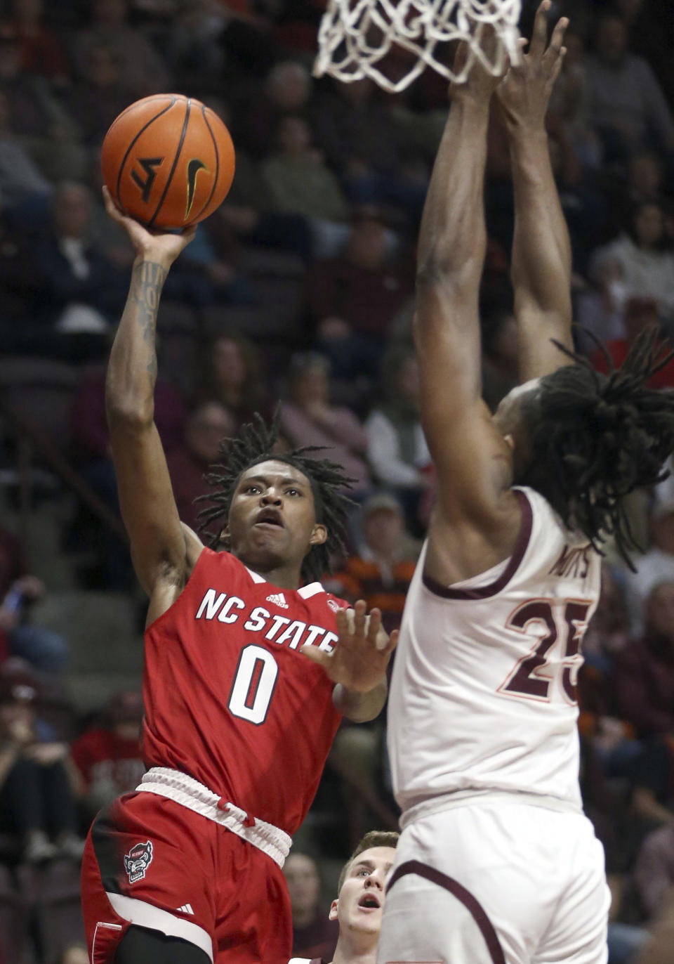 North Carolina State's Terquavion Smith (0) shoots while defended by Virginia Tech's Justyn Mutts (25) during the first half of an NCAA college basketball game Saturday, Jan. 7, 2023, in Blacksburg, Va. (Matt Gentry/The Roanoke Times via AP)
