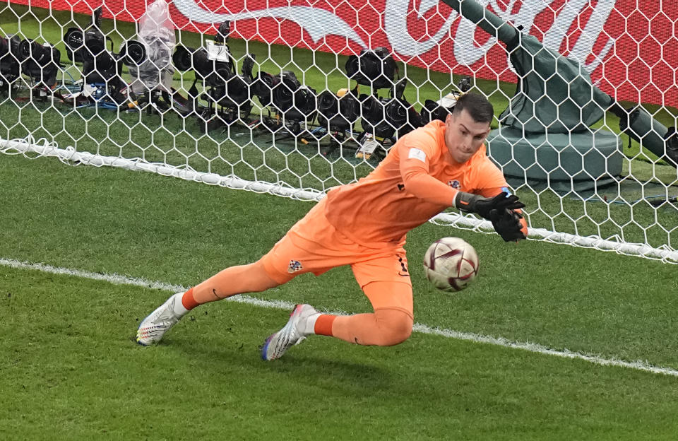 Croatia's goalkeeper Dominik Livakovic makes a save during the World Cup semifinal soccer match between Argentina and Croatia at the Lusail Stadium in Lusail, Qatar, Tuesday, Dec. 13, 2022. (AP Photo/Pavel Golovkin)