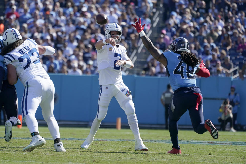 Indianapolis Colts quarterback Matt Ryan (2) throws over Tennessee Titans linebacker Bud Dupree (48) during the first half of an NFL football game Sunday, Oct. 23, 2022, in Nashville, Tenn. The pass was intercepted by Tennessee Titans safety Andrew Adams and run back for a touchdown. (AP Photo/Mark Humphrey)