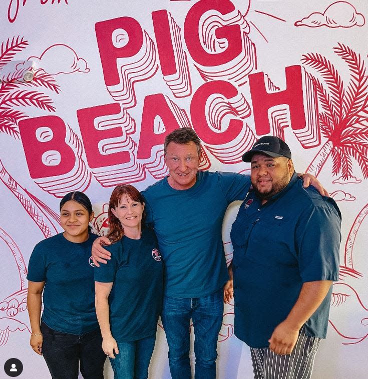 NHL legend Wayne Gretzky poses with staff at Pig Beach BBQ on Wednesday, Feb. 28 at their West Palm Beach location.