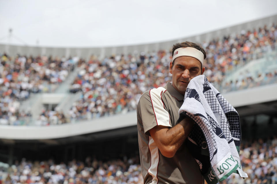 Switzerland's Roger Federer wipes his face during his first round match of the French Open tennis tournament against Italy's Lorenzo Sonego at the Roland Garros stadium in Paris, Sunday, May 26, 2019. (AP Photo/Michel Euler )