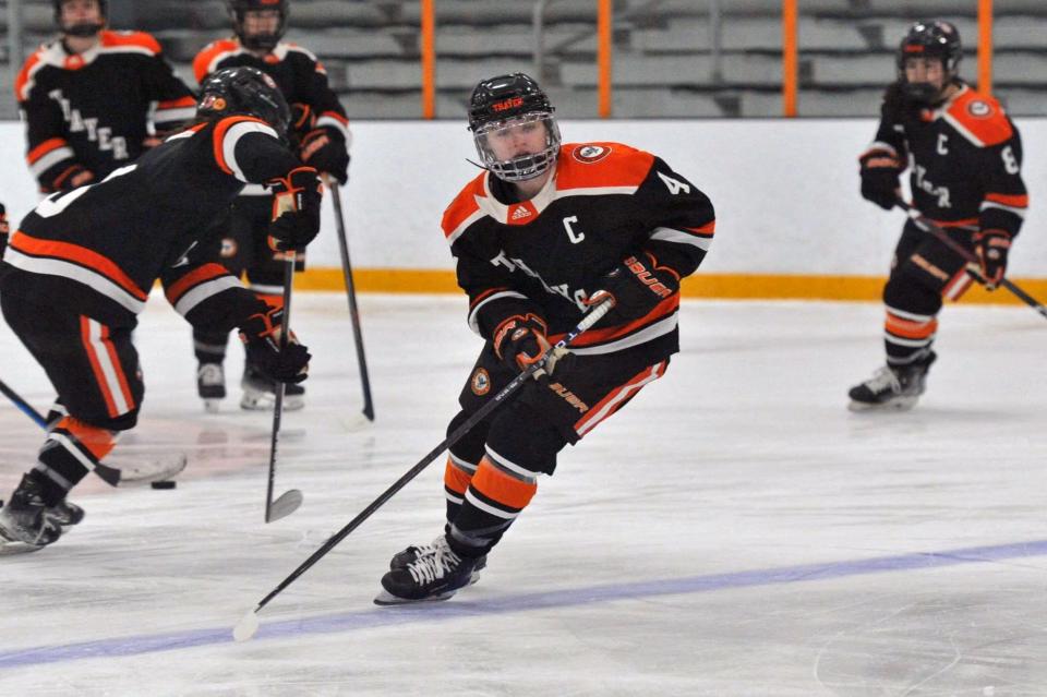 Thayer Academy's Morgan McGathey of Braintree passes to a teammate as Middlesex defender Luisa Ferrari, left, moves in during girls varsity high school hockey at the Thayer Sports Center in Braintree, Saturday, Jan. 27, 2024.