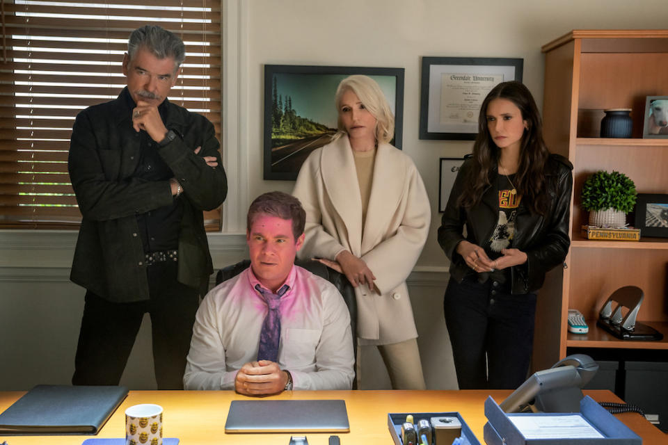 (L to R) Pierce Brosnan, Adam Devine (with pink on his face), Ellen Barkin and Nina Dobrev in The Out-Laws