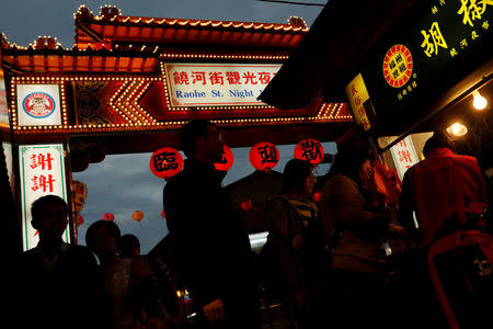 Tourist stroll through a food stall at Raohe street Night Market in Taipei, Taiwan January 18, 2017. REUTERS/Tyrone Siu