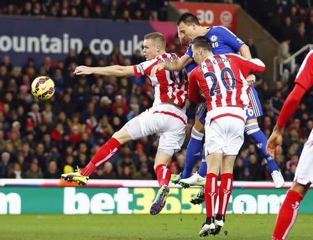 Chelsea's John Terry (R in blue) heads the opening goal during their English Premier League soccer match against Stoke City at the Britannia Stadium in Stoke-on-Trent, northern England December 22, 2014. REUTERS/Darren Staples