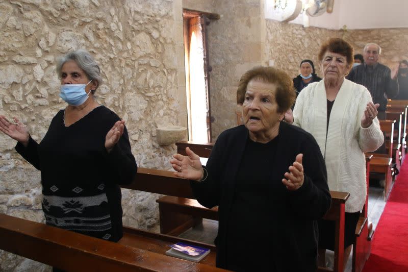 Faithful members sing during a liturgy at the Church of St. George in Kormakitis