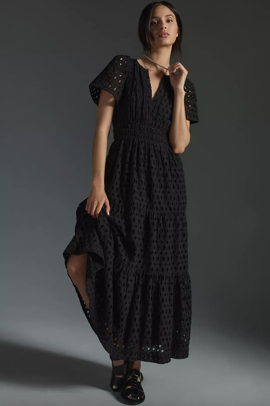model wearing black sandals and black The Somerset Maxi Dress: Eyelet Edition (photo via Anthropologie)