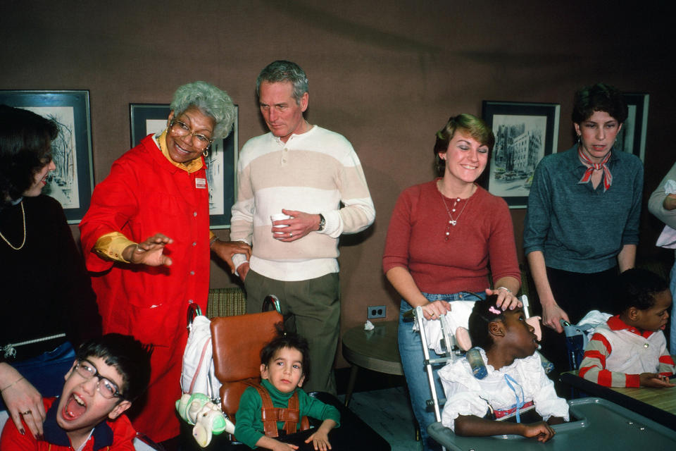 American actor, director, and philanthropist Paul Newman young (1925 - 2008) visits with children and staff at a houndling hospital, New York, New York, 1983.