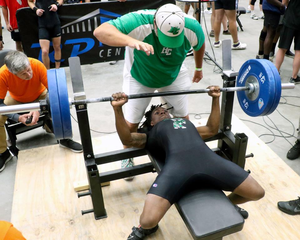 Haines City senior Nashon Paul completes a lift in the bench in the 139-pound weight class on Saturday at the 2023 FHSAA Boys Weightlifting Meet at the RP Funding Center.