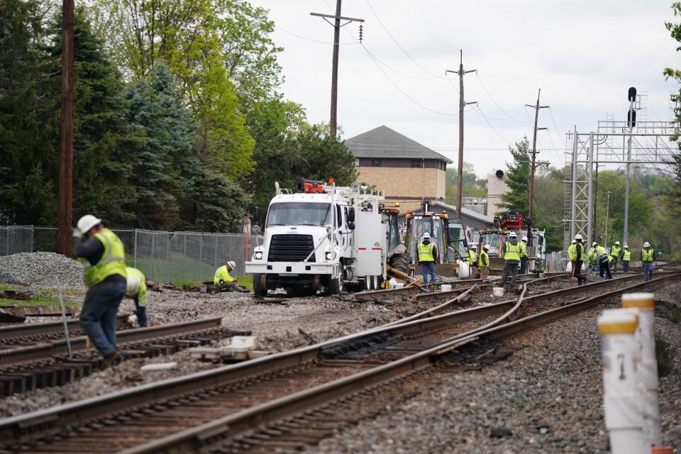 CSX crews work to remove substances from train cars following a derailment, pictured, Sunday, April 21, 2024, at the border between Wyoming and Lockland, Ohio.