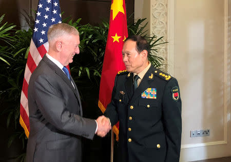 FILE PHOTO: U.S. Defense Secretary Jim Mattis and China's Defense Minister Wei Fenghe greet each other ahead of talks in Singapore, October 18, 2018. REUTERS/Phil Stewart/File Photo
