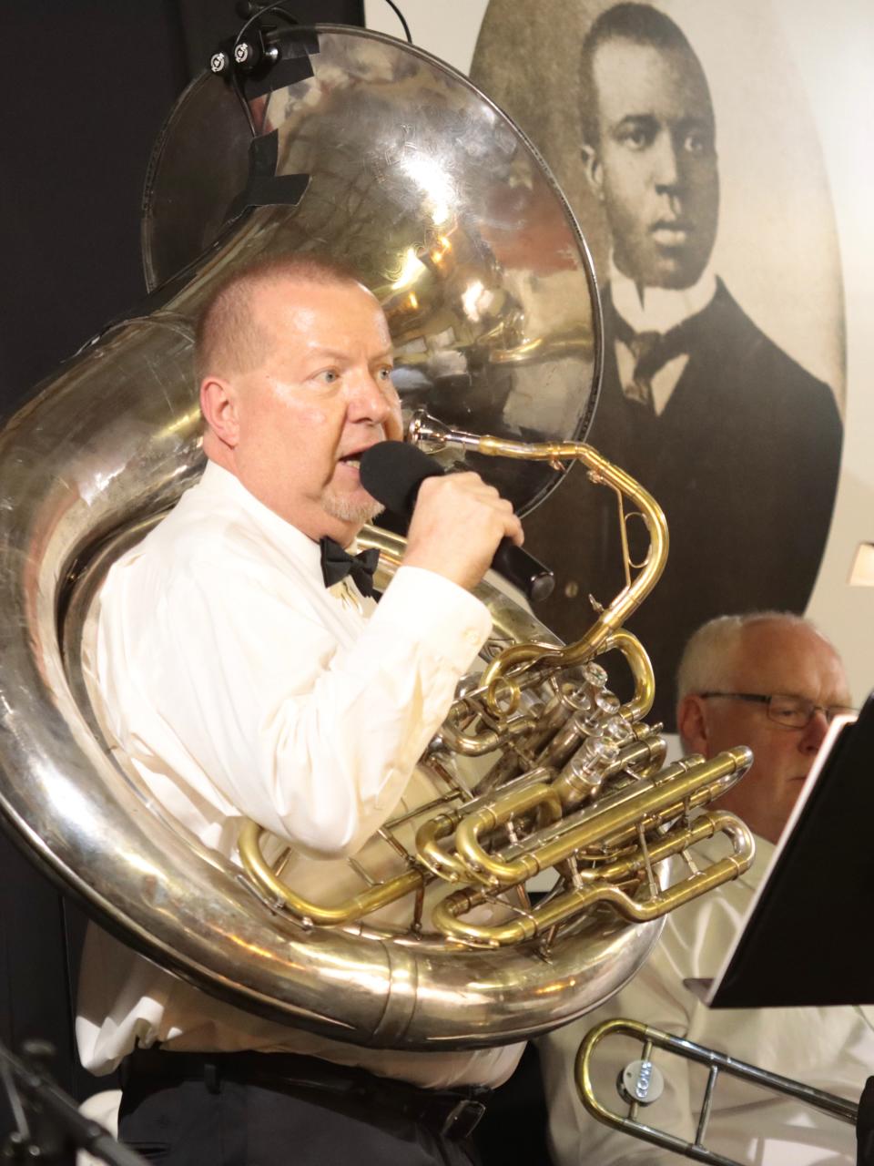 River Raisin Ragtime Revue executive director William Pemberton addresses the audience July 9, 2022, during R4's Ragtime Extravaganza in Adrian. Behind Pemberton is a portrait of the most famous ragtime composer, Scott Joplin.