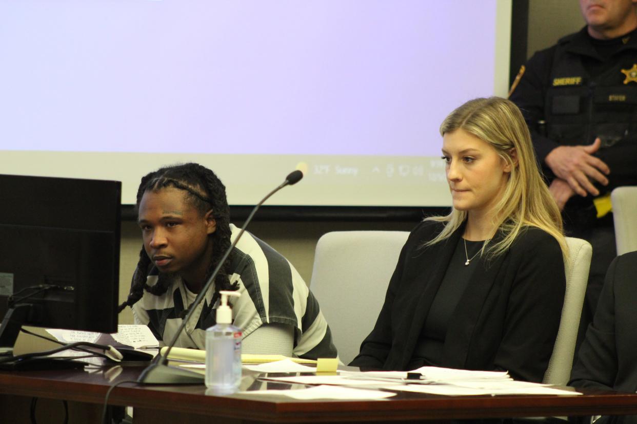 Jonathon Myers, left, sits Monday in Delaware County Common Pleas Court, where Judge David Gormley sentenced him to 25 years in prison for shooting at motorists and Columbus police on March 11 along Interstate 71.  Seated next to Myers is Alexis Dodge, a paralegal with Dodgion Law Offices.