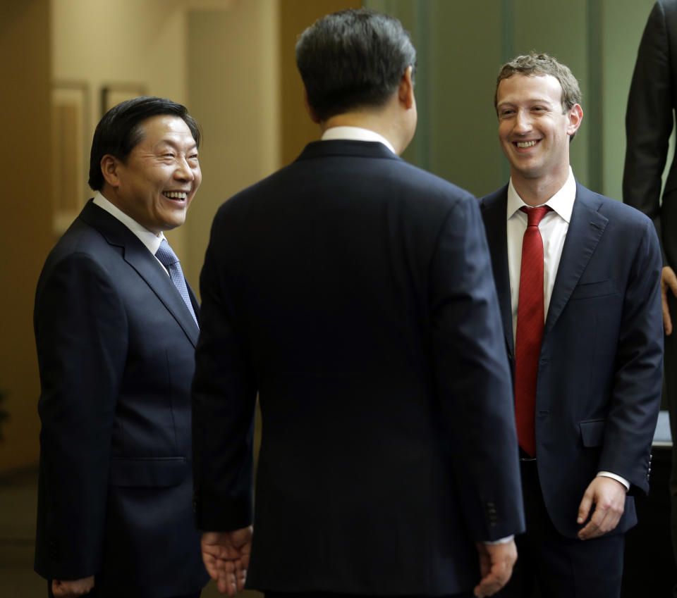 FILE - In this Sept. 23, 2015, file photo, Chinese President Xi Jinping, center, talks with Facebook Chief Executive Mark Zuckerberg, right, as Lu Wei, left, China's Internet czar, looks on during a gathering of CEOs and other executives at Microsoft's main campus in Redmond, Wash. Lu was standing trial Friday, Oct. 19, 2018 on corruption allegations, state media reported. (AP Photo/Ted S. Warren, Pool, File)