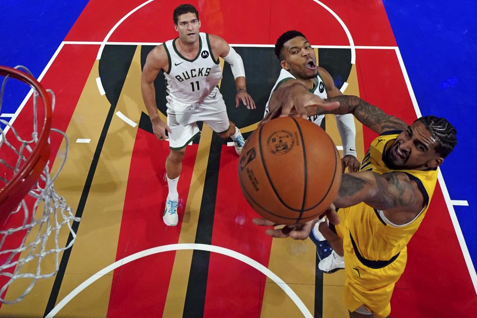 Indiana Pacers forward Obi Toppin, right, shoots the ball against Milwaukee Bucks forward Giannis Antetokounmpo during a semifinal game in the NBA basketball In-Season Tournament, Thursday, Dec. 7, 2023, in Las Vegas. (Kyle Terada/Pool Photo via AP)