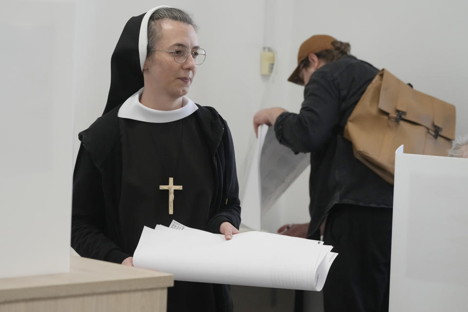 A nun votes during local elections in Warsaw, Poland, Sunday, April 7, 2024. Voters across Poland are casting ballots in local elections Sunday in the first electoral test for the coalition government of Prime Minister Donald Tusk nearly four months since it took power. (AP Photo/Czarek Sokolowski)