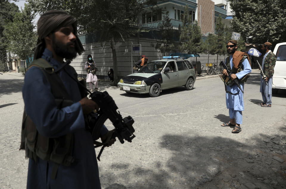 Taliban fighters stand guard at a checkpoint in the Wazir Akbar Khan neighborhood in the city of Kabul, Afghanistan, Wednesday, Aug. 18, 2021. The Taliban declared an 