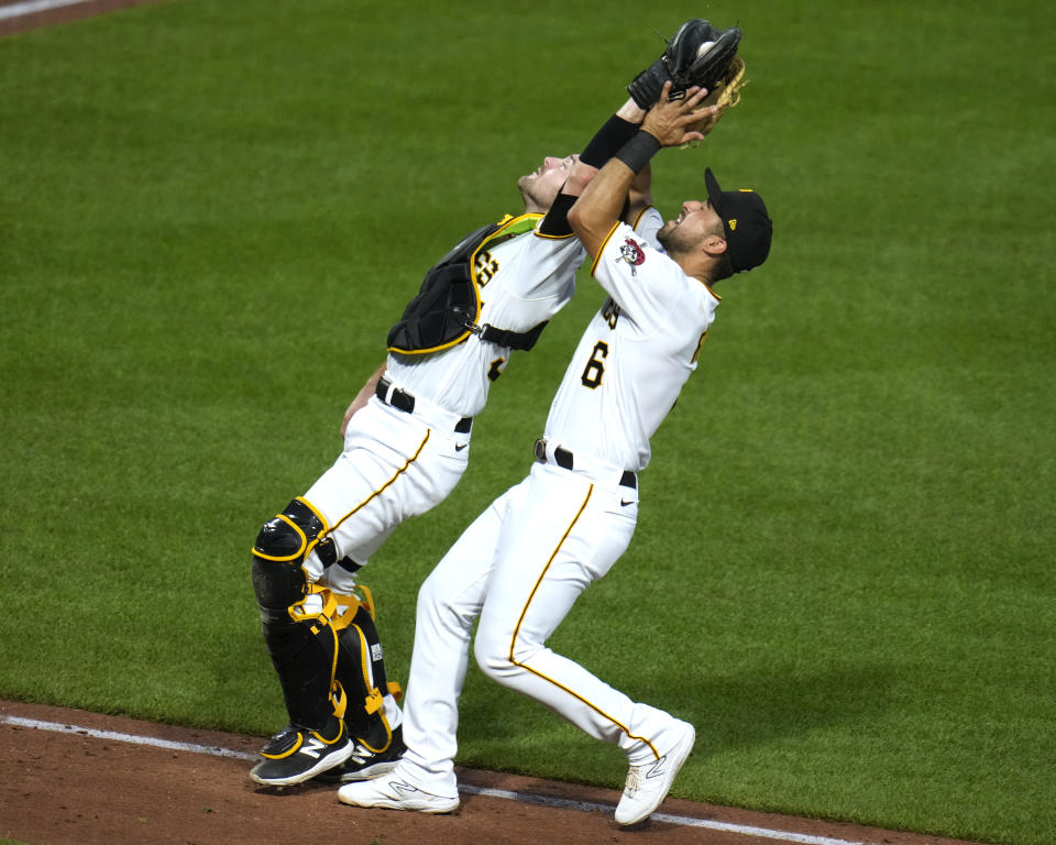 Pittsburgh Pirates catcher Jason Delay, left, makes the catch in front of first baseman Alfonso Rivas on a foul ball hit by Atlanta Braves' Marcell Ozuna during the fifth inning of a baseball game in Pittsburgh, Tuesday, Aug. 8, 2023. (AP Photo/Gene J. Puskar)