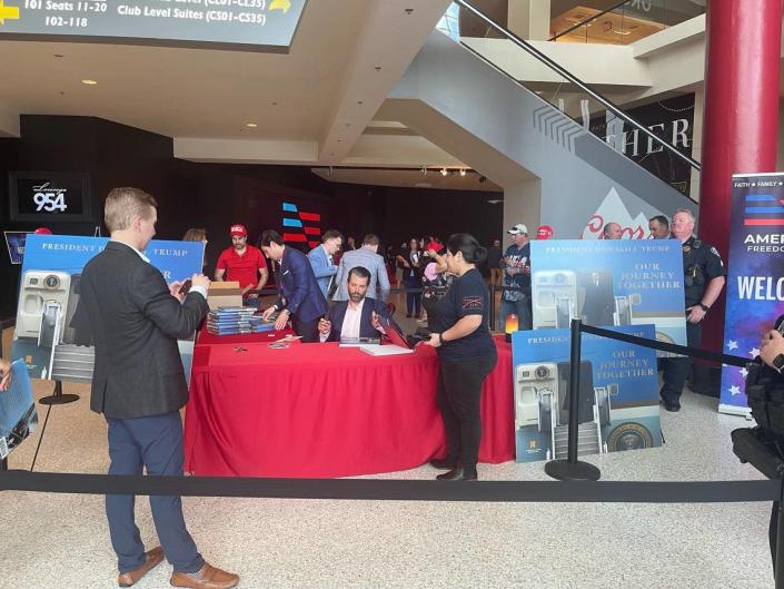 Donald Trump Jr. signs copies of his father&#x002019;s book &#x00201c;Our Journey Together.&#x00201d;