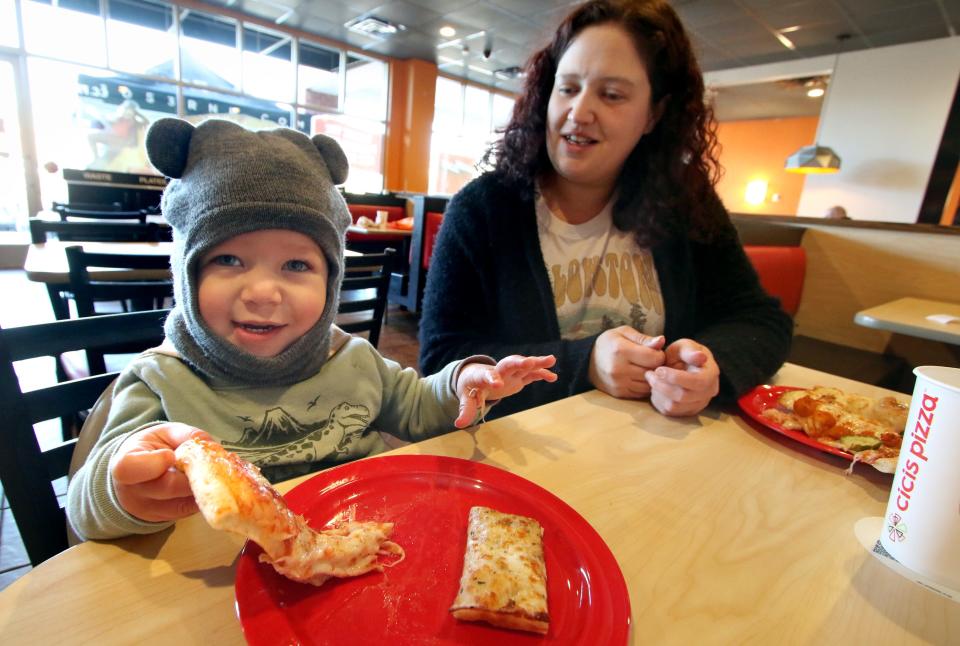 Lyndsay Shaffer watches one-year-old Giovanni Brown enjoy his pizza inside Cicis Pizza during a customer appreciation event Tuesday, Feb. 6, 2024.