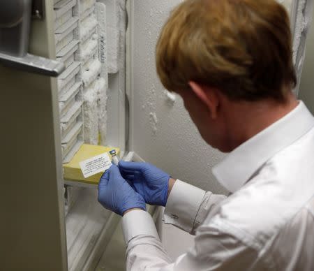 Professor Adrian Hill, Director of the Jenner Institute, and Chief Investigator of the trials, holds a phial containing the Ebola vaccine at the Oxford Vaccine Group Centre for Clinical Vaccinology and Tropical Medicine (CCVTM) in Oxford, southern England September 17, 2014. REUTERS/Steve Parsons/Pool