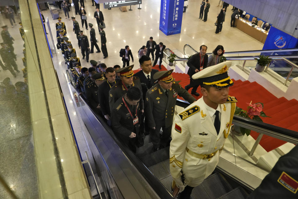 Military delegates are escorted by a Chinese honor guard as they arrive to attend the opening ceremony for the Xiangshan Forum, a gathering of the region's security officials, in Beijing, Monday, Oct. 30, 2023. (AP Photo/Ng Han Guan)