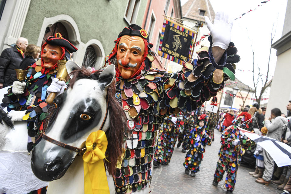 A group of fools attend a parade during the great fool's leap through the city centre of Konstanz, Germany, Sunday, Feb. 23, 2020. (Felix Kaestle/dpa via AP)