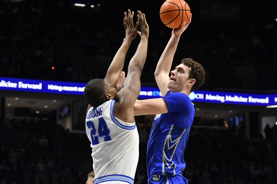 CORRECTS NAME OF CREIGHTON PLAYER AND ADDS NAME OF XAVIER PLAYER - Creighton center Ryan Kalkbrenner (11) takes a shot over Xavier forward Abou Ousmane (24) during the second half of an NCAA college basketball game in Cincinnati, Ohio, Saturday, Feb. 10, 2024. (AP Photo/Timothy D. Easley)