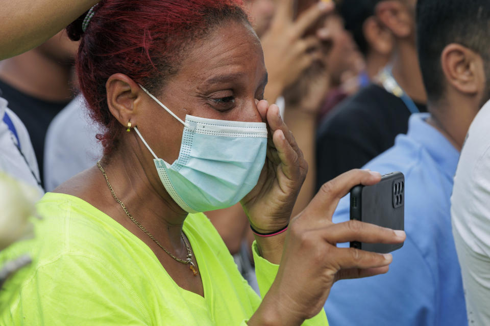 Venezuelan migrant Rossana Greaves wipes her tears during a vigil for the eight migrants that were killed and several others that were injured the day before while waiting at a bus stop, in Brownsville, Texas, Monday, May 8, 2023. (AP Photo/Michael Gonzalez)