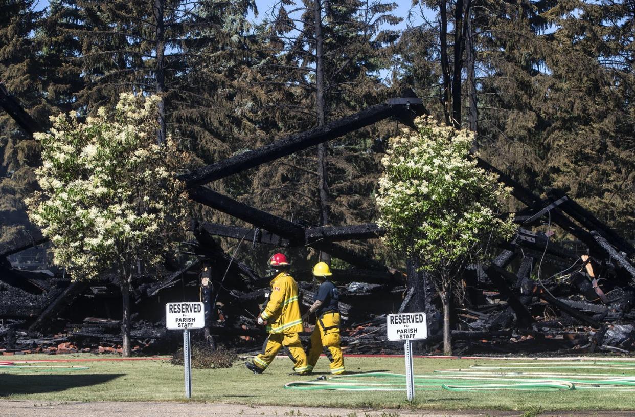 <span class="caption">Firefighters walk past the remains of a Catholic church that was on fire, in Morinville, Alta. in June 2021.</span> <span class="attribution"><span class="source">THE CANADIAN PRESS/Jason Franson</span></span>